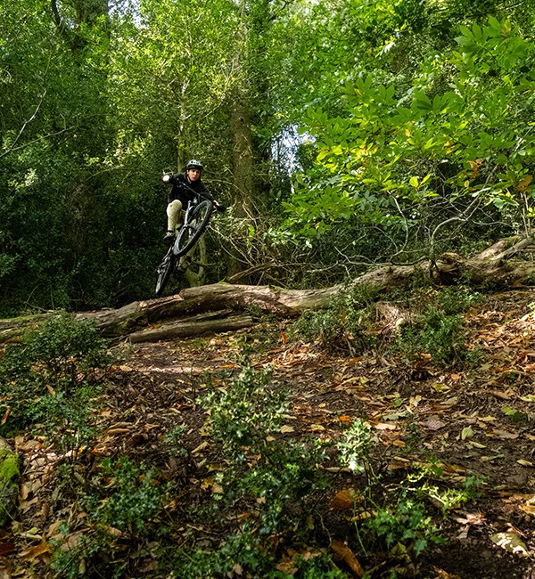 Merida One-Sixty FR being jumped over a downed tree